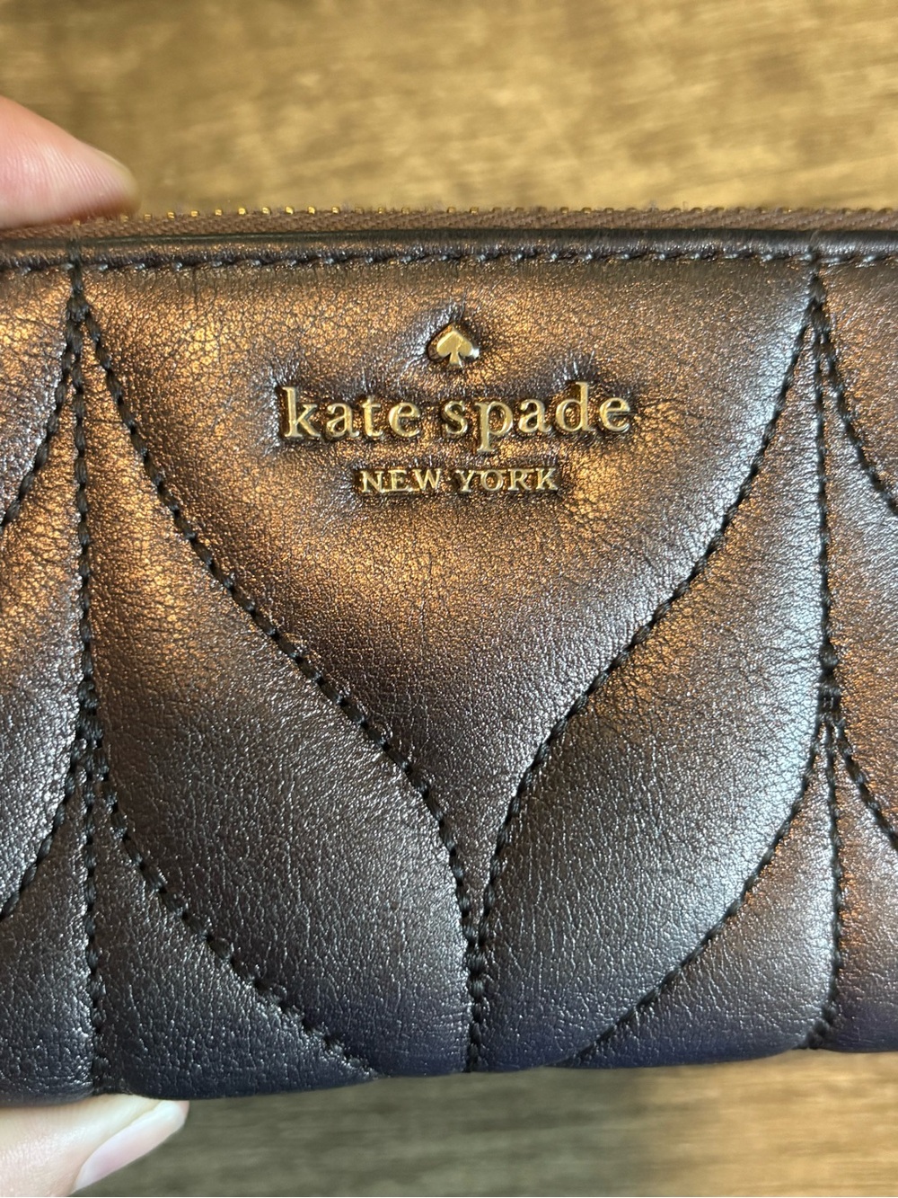 Like New Kate Spade metallic quilted leather wallet with gold logo